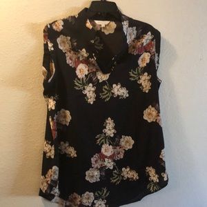 Sleeveless black top with flowers